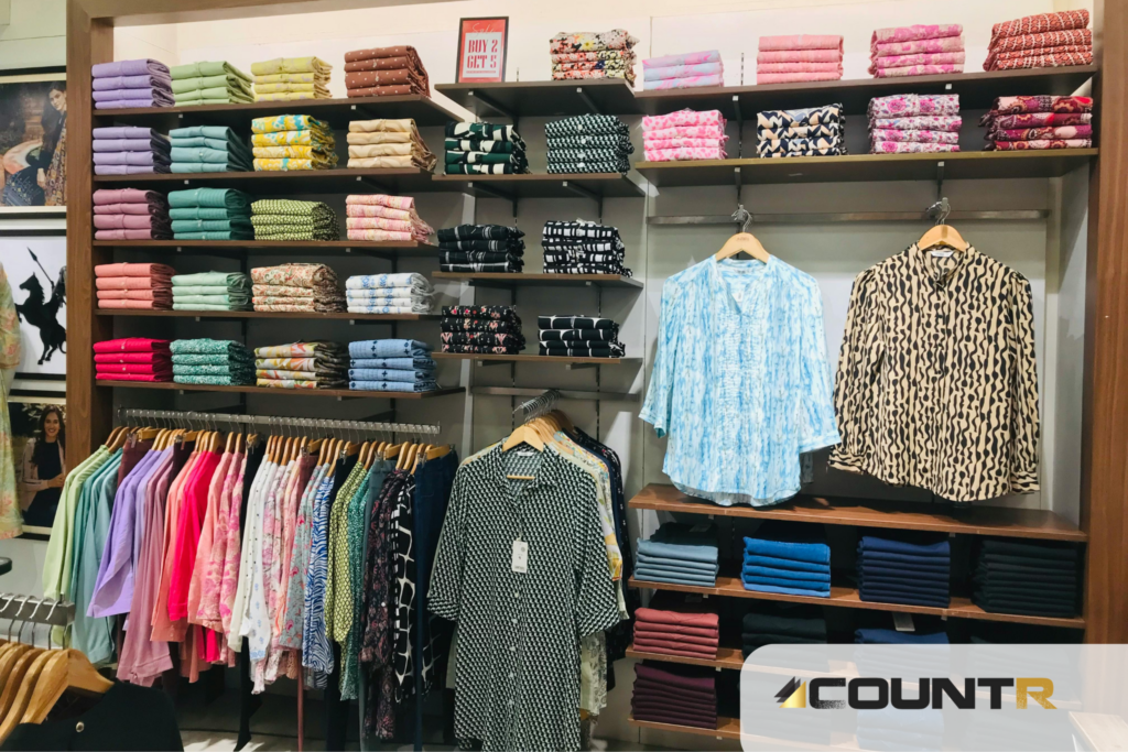 Organized clothing shelves and hanging garments in a retail store, aligned with CountR-based layout and flow optimization