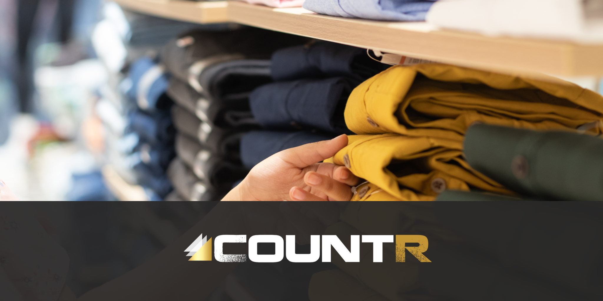 Analyzing In-Store Engagement with CountR Customer hand selecting folded pants from a retail shelf in a clothing store