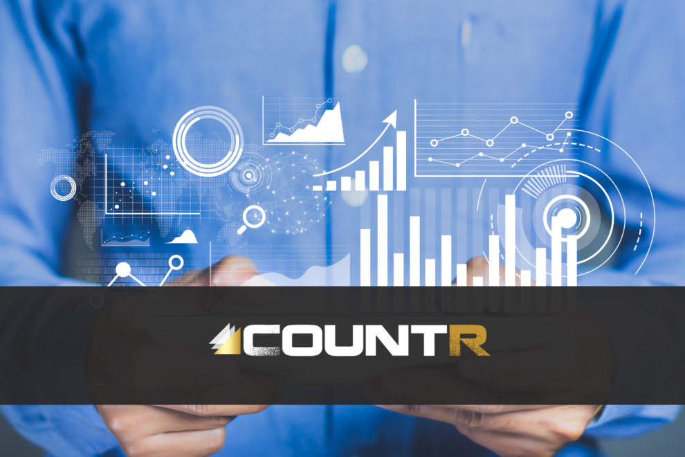 Businessperson analyzing digital visitor data with CountR logo overlayed