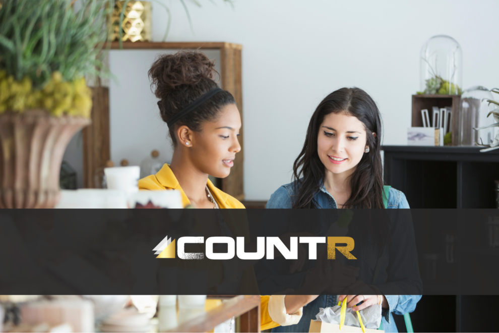 Retail staff advising a shopper on a product, demonstrating how CountR analytics optimize staffing during key customer moments