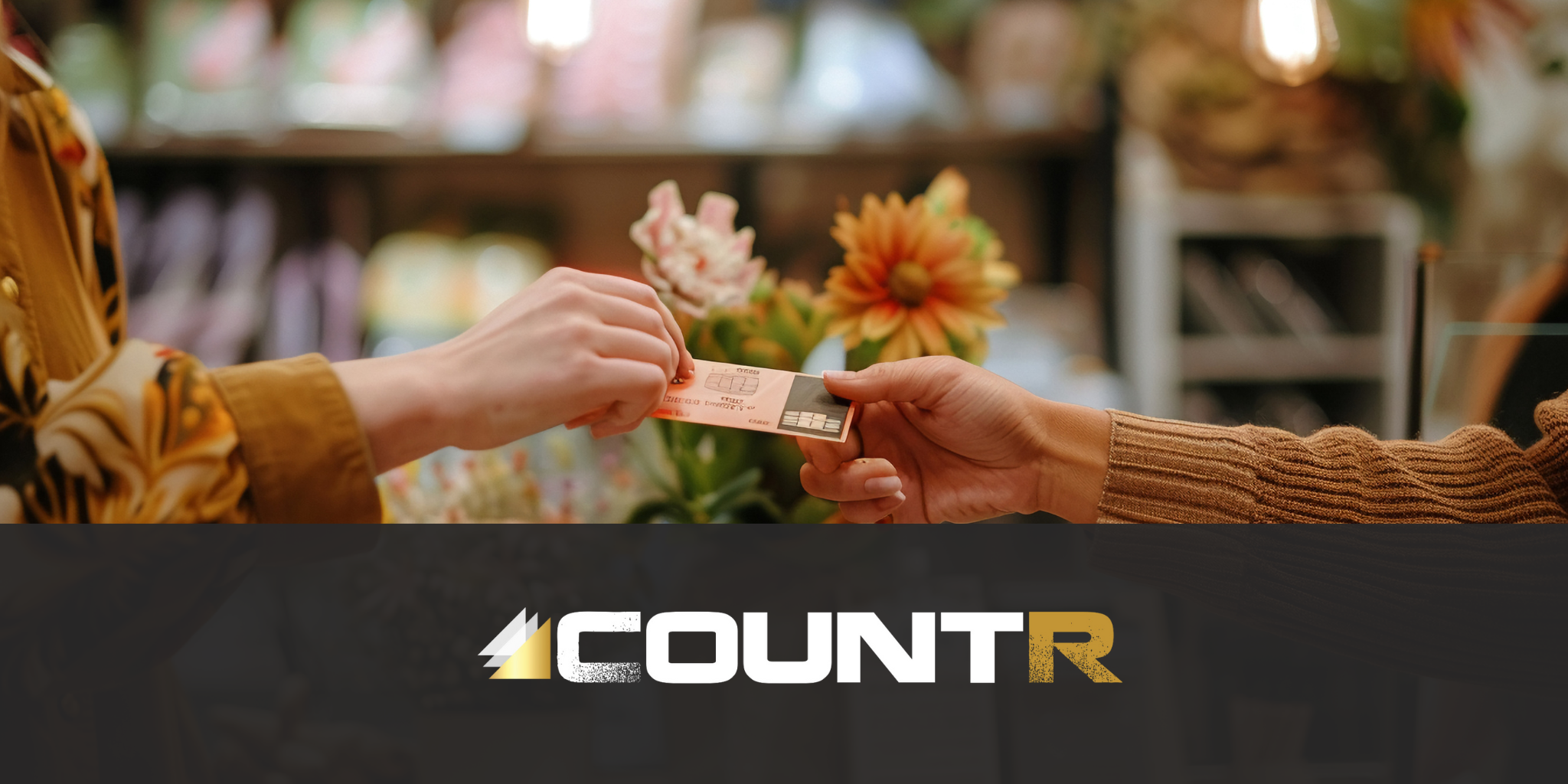 close-up of two people exchanging a payment card in a boutique store while Countr collects footfall data