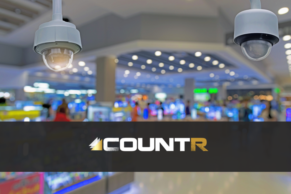 Close-up of security cameras in a retail store with CountR logo overlay.