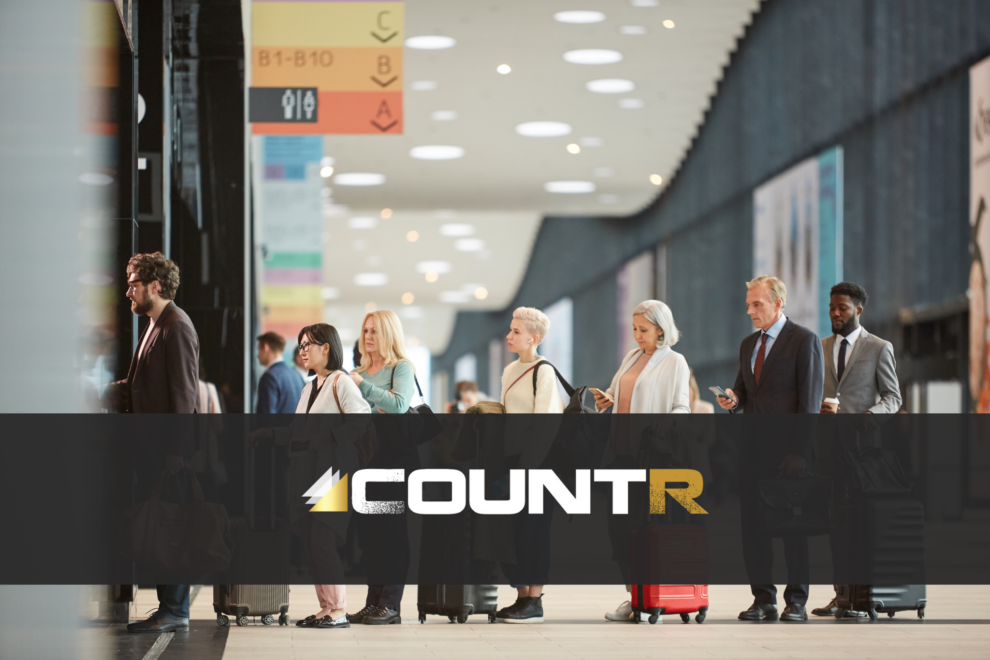 Travelers waiting in line at an airport terminal with CountR logo overlay
