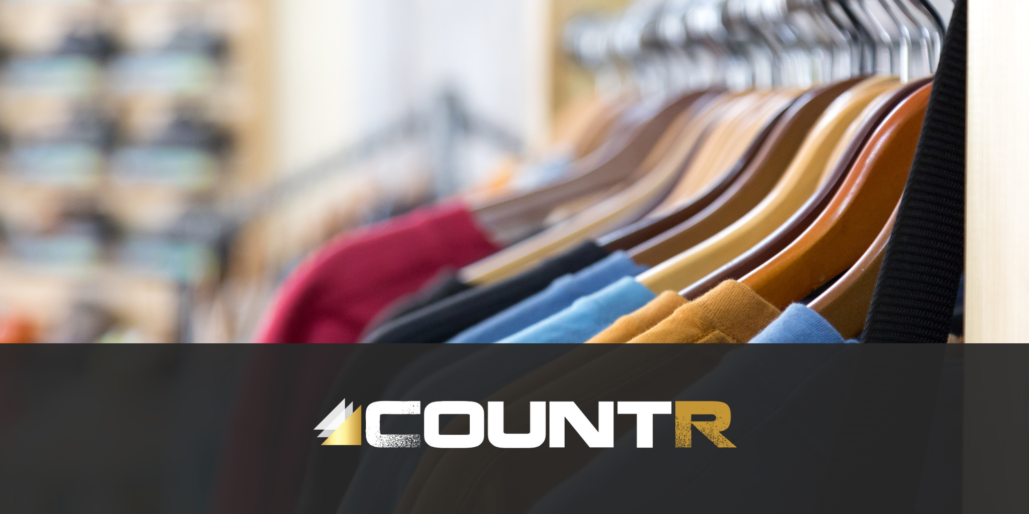 Clothing store rack with colorful shirts and the CountR logo representing reliable people counting systems.