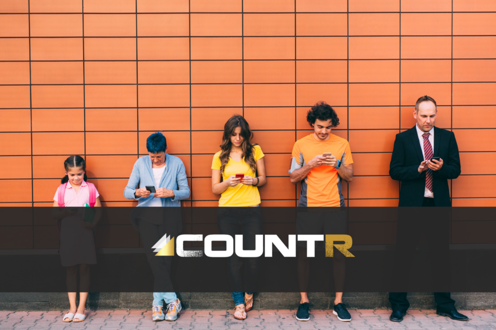 Group of people of different ages using smartphones, representing customer demographics with CountR retail analytics logo